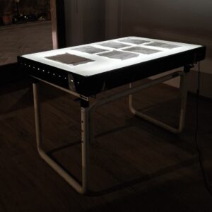 Elena Marini, 𝘓𝘜𝘟 100𝘹150, 2025, tavolo luminoso, pagine di manuale di uso e manutenzione.
